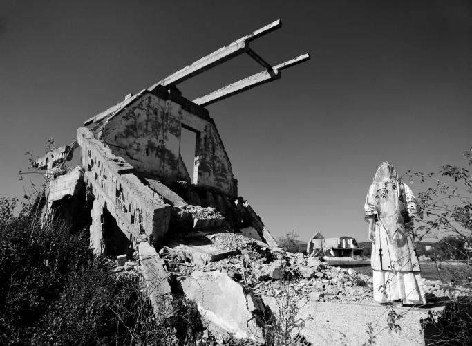 Lala Meredith-Vula, Model at destroyed Serbian policemen's homes, Korenice, Kosova, 2007, black and white photographic print, 101x134 cm