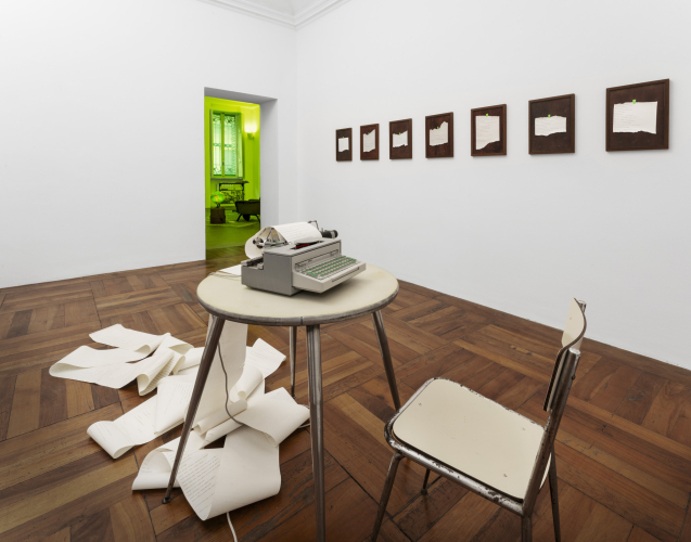 Roberto Casti, Aleph (Milano-Berlino-Lisbona-Milano), 2023–ongoing, typewriter, paper roll, ink, table, chair, variable dimensions, ph Lorenzo Gastaldi