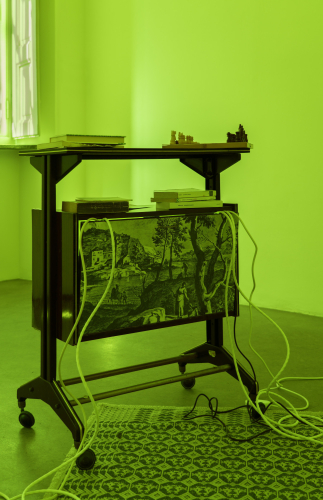 Roberto Casti, From the depths of the Earth (sideboard), 2026, sideboard, books, 45 rpm vinyl records, photograph, chessboard, cables, speakers, LED light, sound, 96 × 85 × 45 cm